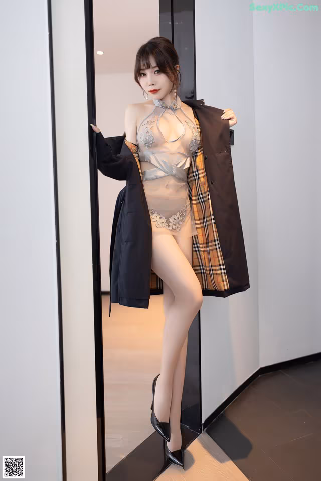 A woman in lingerie posing in front of a mirror.