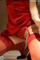 A woman in a red dress and red stockings.