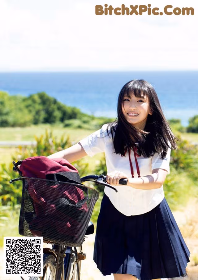 A young woman riding a bike with a basket on the back.