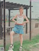 A woman standing next to a soccer ball on a field.