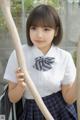 A young woman in a school uniform holding a baseball bat.