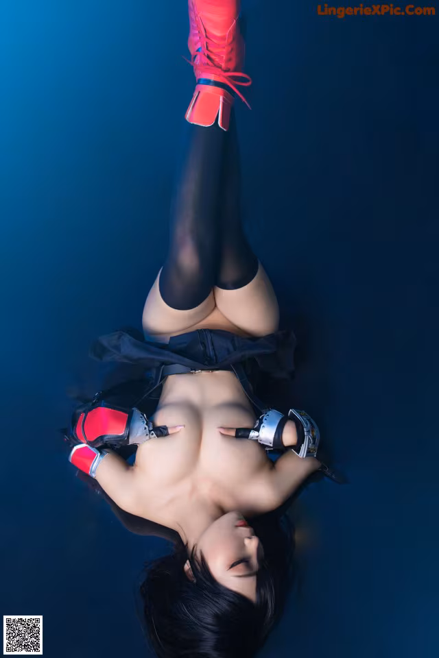 A woman laying on the ground with her legs up in the air.